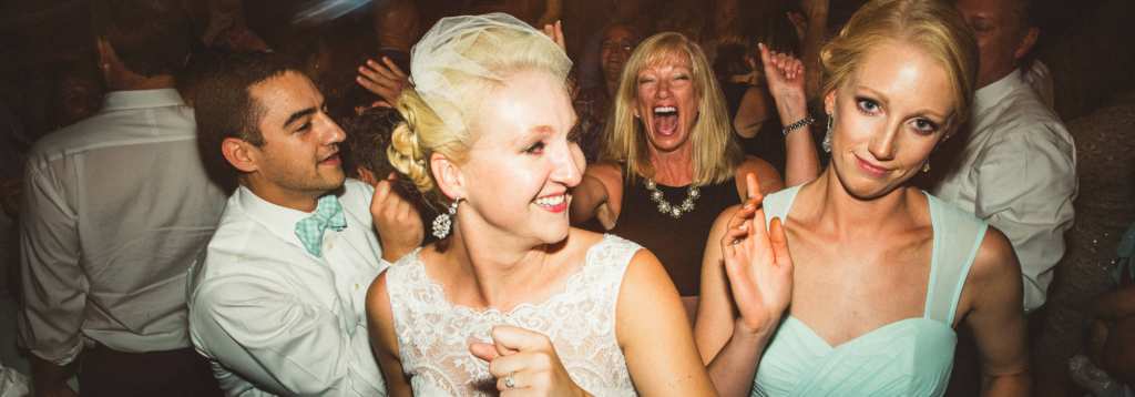 A Bride Dancing on a Packed Dance Floor with her Charlotte Wedding DJ